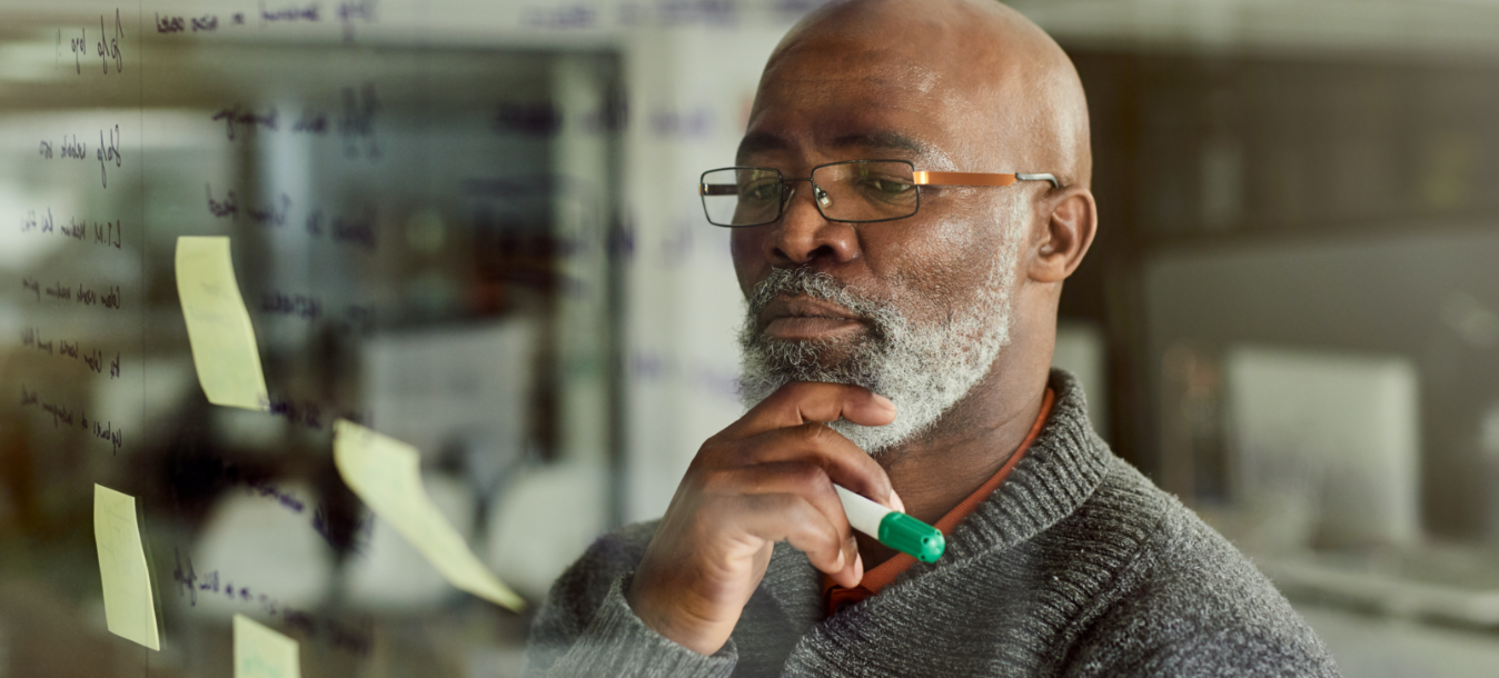 man thinking in front of board